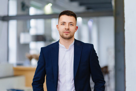 a young attractive man in a blue business suit. the portrait of an entrepreneur.