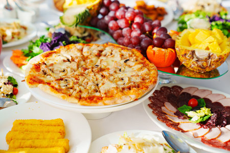 pizza with meat and mushrooms on the table.の写真素材