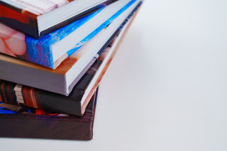 photobooks stacked on top of each other on a white table.の写真素材