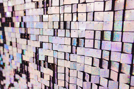 a wall of squares of shiny sequins. an element of decor for a holidayの写真素材