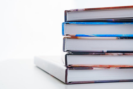 photobooks stacked on top of each other on a white table.の写真素材