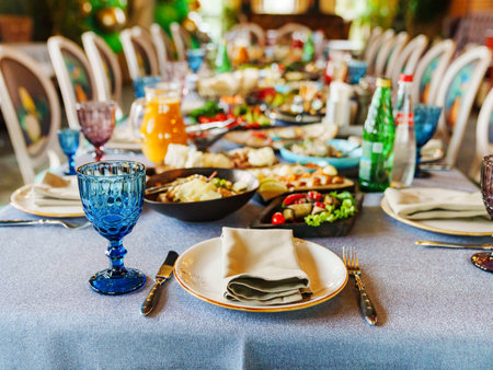 big table served with salads, vegetables and snacks for the banquet.の写真素材
