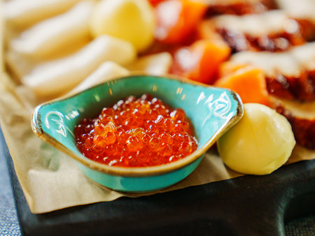 beautiful blue bowl with red caviar. fish delicacy for feasting.の写真素材