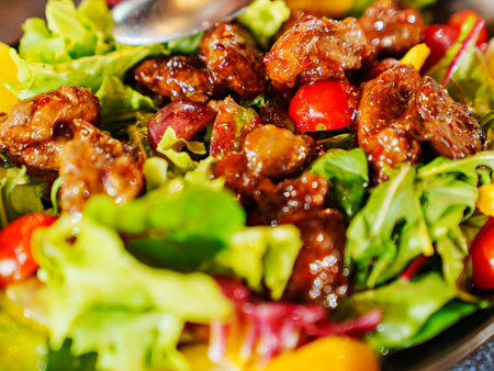 a plate of hot salad with caramelized meat.の写真素材