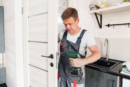 The master repairs or installs the door handle on the interior door.