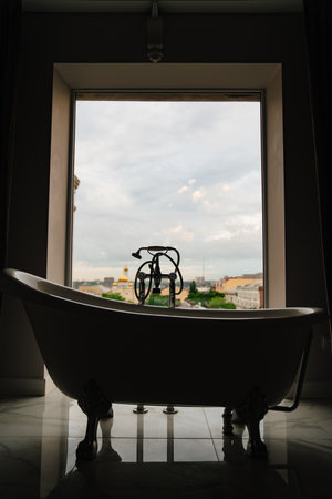 bathtub in front of a large window. retro-style bathroomの写真素材