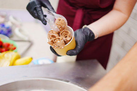 Making ice cream roll from cream and cocoa.の写真素材