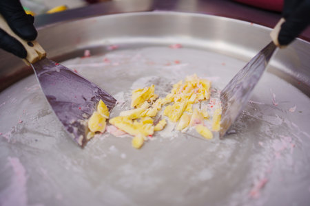 Making ice cream roll from cream and bananaの写真素材