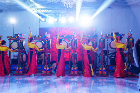 Dancers in national costumes dance a traditional Korean dance with drumsのeditorial素材