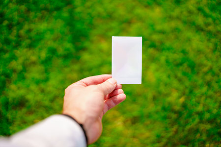 Blank white card on the background of a green lawn.