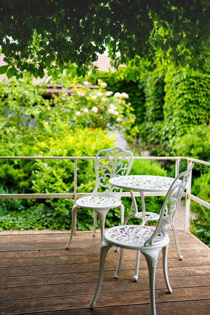 White lace metal table and chairs on the terrace.の写真素材