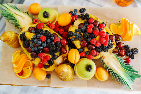 Beautiful and original serving of fruits and berries in pineapple.の写真素材