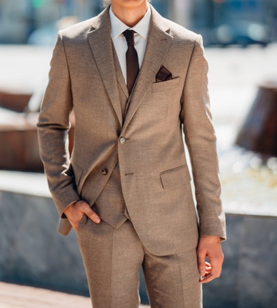 without a face. A man in a light-colored three-piece suit.
