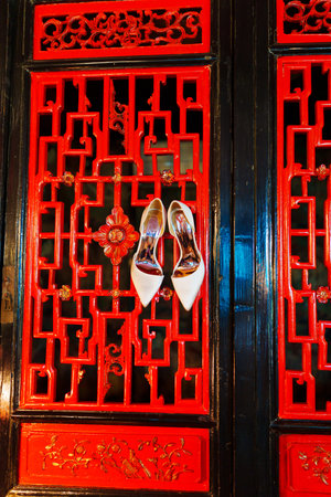 White womens heeled shoes on a red screen in oriental style.の写真素材