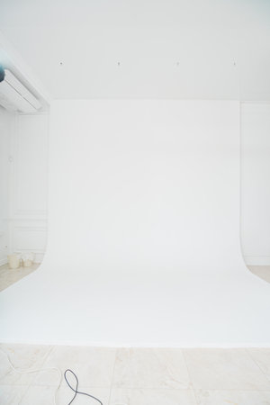 A photo studio with a white cyclorama for a professional photo shoot.の写真素材