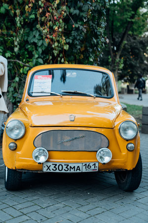 A yellow retro Zaporozhets at an exhibition of old Soviet cars.のeditorial素材