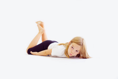 Cheerful teenage girl in white t-shirt and black breeches on white backgroundの写真素材