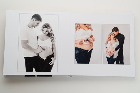 The pages of a photo book with color photos of a pregnant blonde and a man.