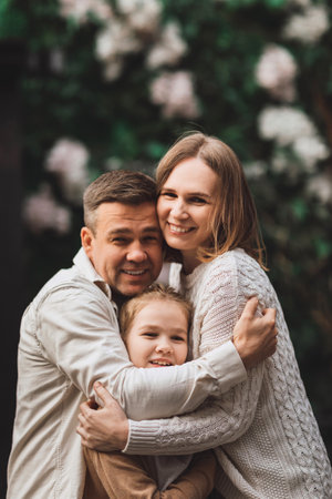 Happy family on a walk in the city. Mom, dad and teenage daughter having fun.の写真素材