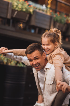 Dad and teenage daughter having fun on a walk in the city.の写真素材