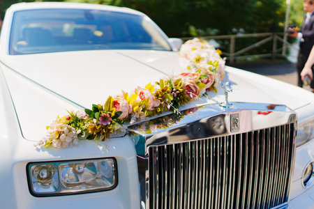White Rolls-Royce decorated with flowers for wedding.のeditorial素材