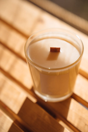 Scented candles on a wooden table.の写真素材