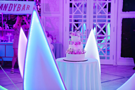 A large white cake decorated with flowers and a mastic doll. Dessert for a girl's birthday.の写真素材