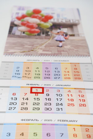 tear-off calendar with photos first of September on a white table. production of souvenirs and gifts with memorable photos in the printing house. Calendar for 2025.の写真素材