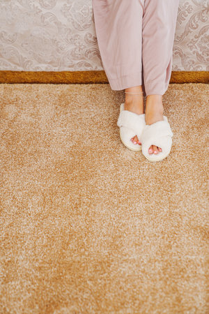 soft white slippers on the beige Interior pile carpet. Long fibers form a high pile. pleasant lint...