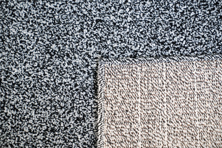close-up dark gray Interior pile carpet made of polypropylene. Long fibers form a high pile....