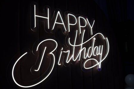 Happy Birthday inscription made of LED strip on a black backgroundの写真素材