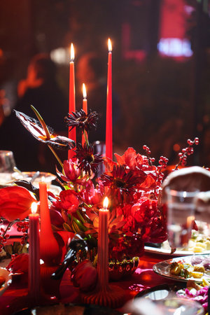 three burning candles on the banquet table in the dark. atmosphere of romance and celebration.