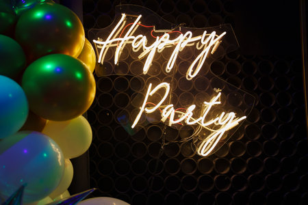 Happy Birthday Lettering LED Strip Light on Black Background with Balloons.の写真素材