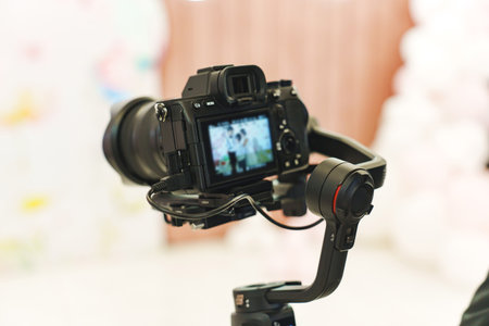 A professional black camera for taking photos and videos at the holiday. photographer and...