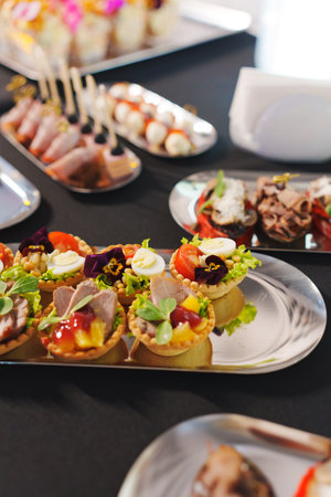 tartlets with pate and salad garnished with flowers. Delicious appetizers for a buffet. A variety of festive menus.の写真素材