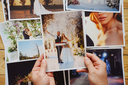 Mens hands put on the table and show wedding photos.の写真素材