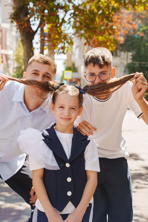 Friends sharing a playful moment in the city with funny hairstylesの写真素材