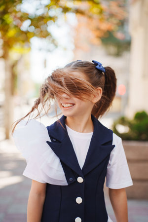 Girl enjoying a sunny day outdoors with playful hair momentの写真素材