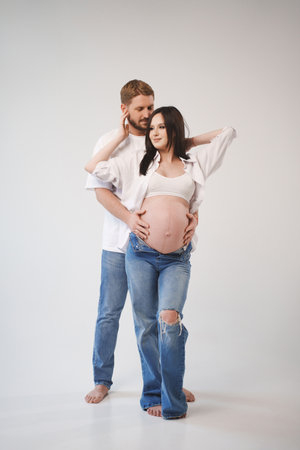 Couple celebrating pregnancy in casual studio setting