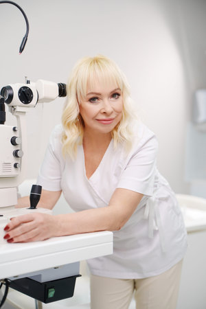 Ophthalmologist working with eye examination equipment