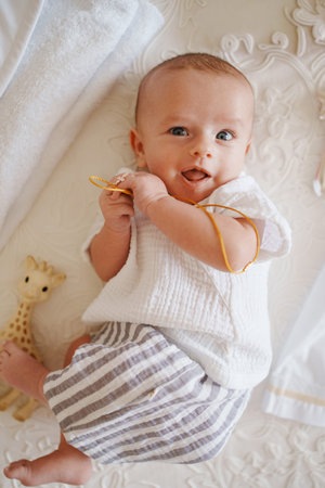 Baby enjoying playtime on soft blanket with toyの写真素材