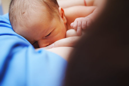 Mother and newborn share feeding moment in hospital