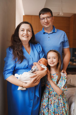 Family poses together with newborn in cozy home setting