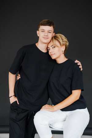 Family portrait in black clothing with a plain background