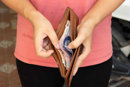 Buyer open bags and 1000 Cambodia Real in bagsの写真素材