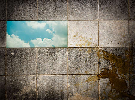 Grunge wall stone and  aperture for looking skyの写真素材