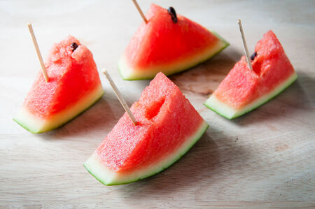 red watermelons fruit stylish on woodの写真素材