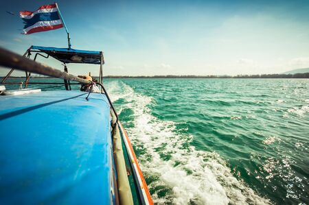 driving a wooden boat in the sea, travel in Thailandの写真素材
