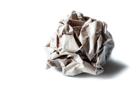 Crumpled brown paper ball isolated on whiteの写真素材