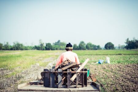 farmer driving tractor in a farm, career life of Thailandの写真素材